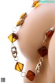 A close up of a bracelet on a mannequin head.