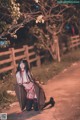 A woman in lingerie sitting on the side of a road.