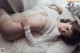 A woman laying on top of a white rug.