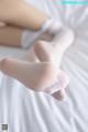 A close up of a person's feet in white socks.