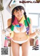 A woman in a white bikini and a colorful scarf.