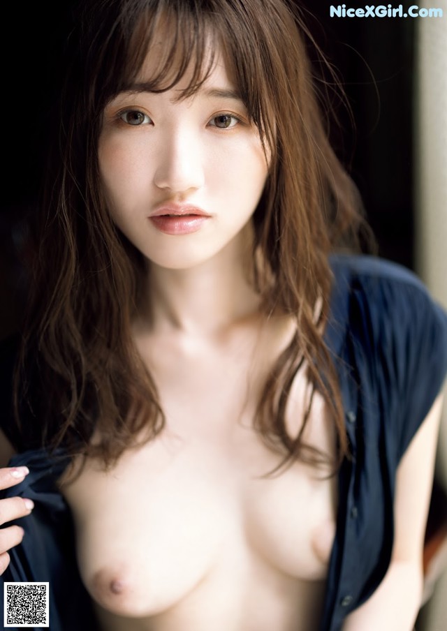 A naked asian woman posing for the camera. 