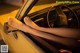 A woman's feet sticking out the window of a car.