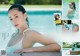 A woman in a white bathing suit sitting on a lounge chair by a pool.